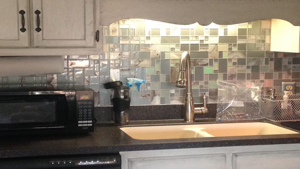 New glass backsplash in kitchen-