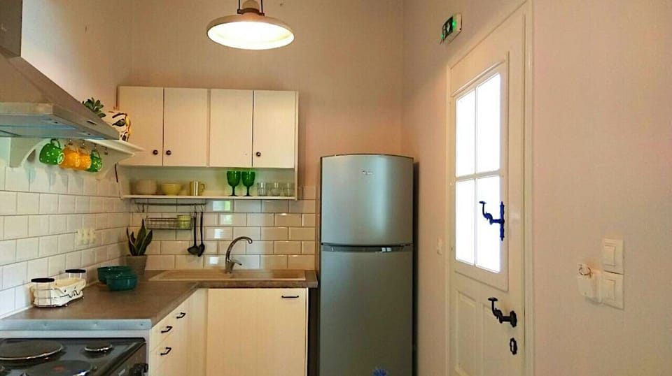The kitchen corner after renovation offers an oven, stove,full size refrigerator