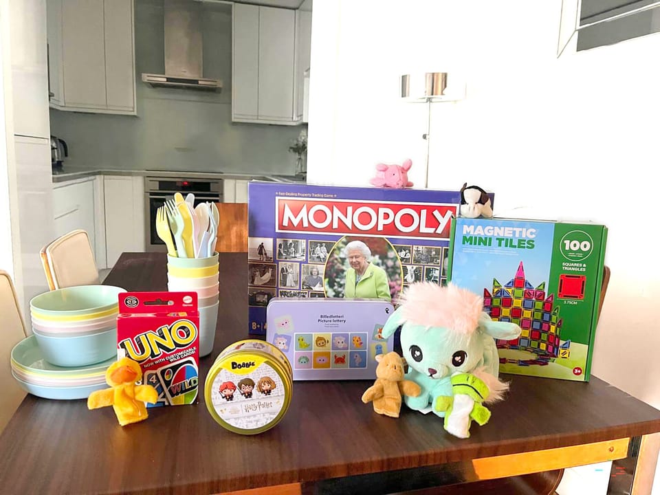 A fun selection of games, child friendly kitchenware and travel cot hire option