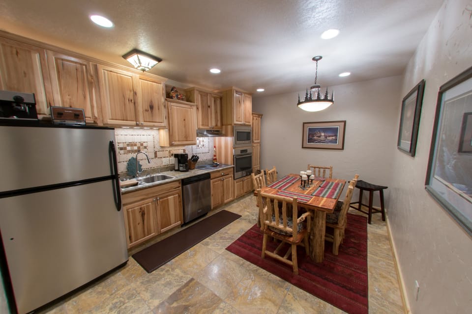 Modern kitchen w/new stainless steel appliances, dishes, pots/pans, and staple