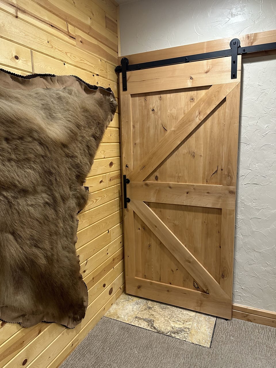 Barn door conceals the alcove with the washer & dryer.