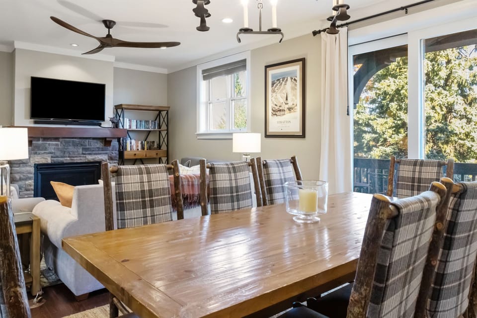 - Rustic dining area with seating for eight and forest views   - Warm lighting and wood accents create mountain charm   - Ideal for family dinners or après-ski gatherings