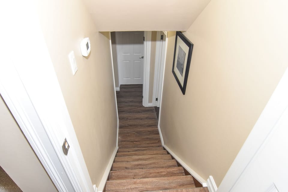 STAIRWAY FROM KITCHEN TO 3RD LEVEL WALKOUT