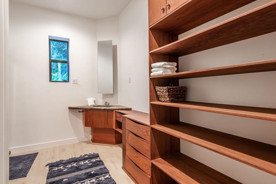 Upper level Master Bathroom features two separate vanities connected by large walk-in shower.