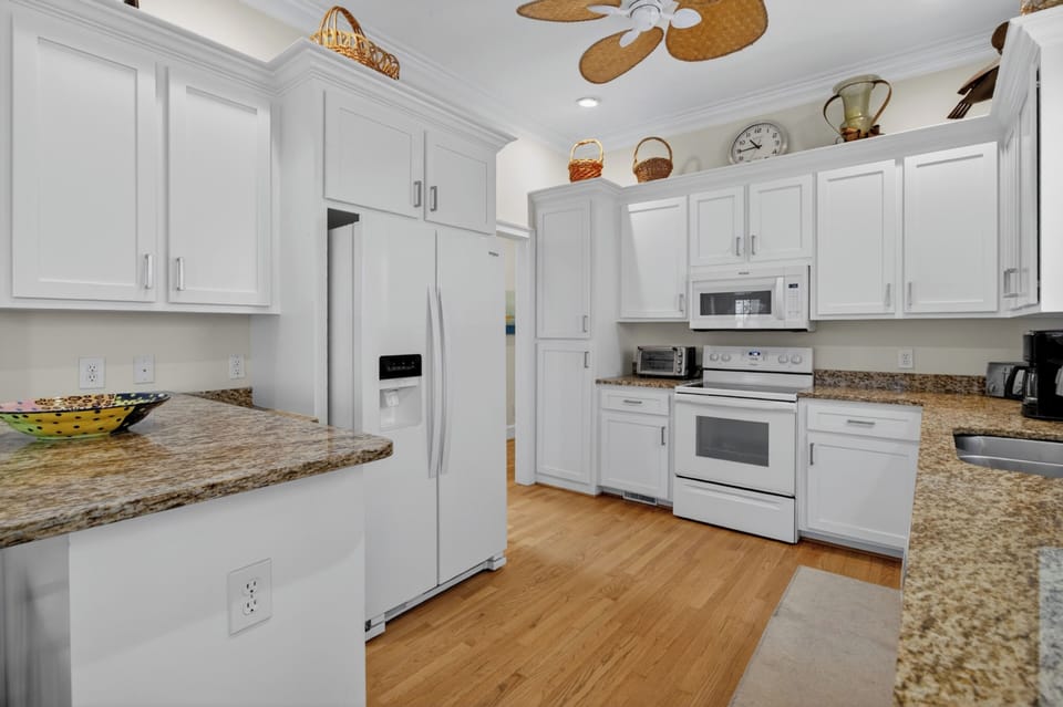 Your fully equipped kitchen features granite countertops, modern appliances, and ample cabinet space—everything you need to prepare meals during your stay.