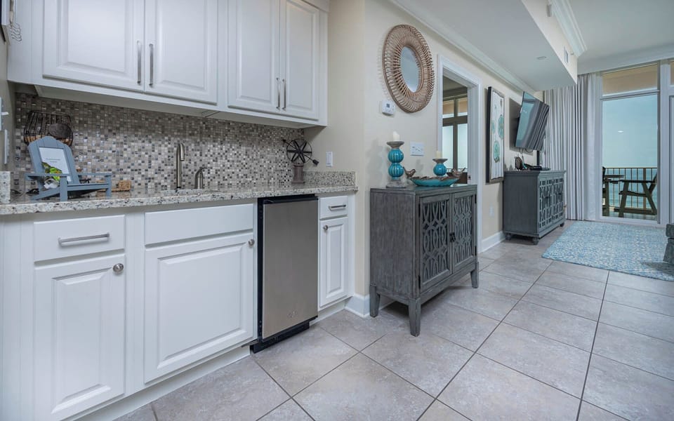 Prepare drinks at the stylish wet bar with an ice maker and decorative accents for a welcoming vibe