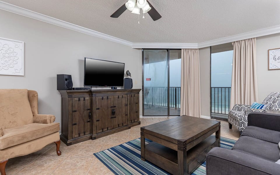Relax in this inviting living area featuring a TV, queen sofa sleeper, and beachfront balcony access