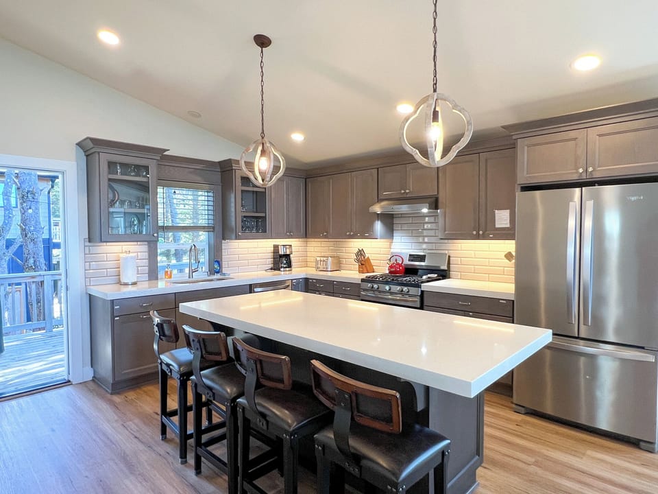 Kitchen with exit to the back deck with grill