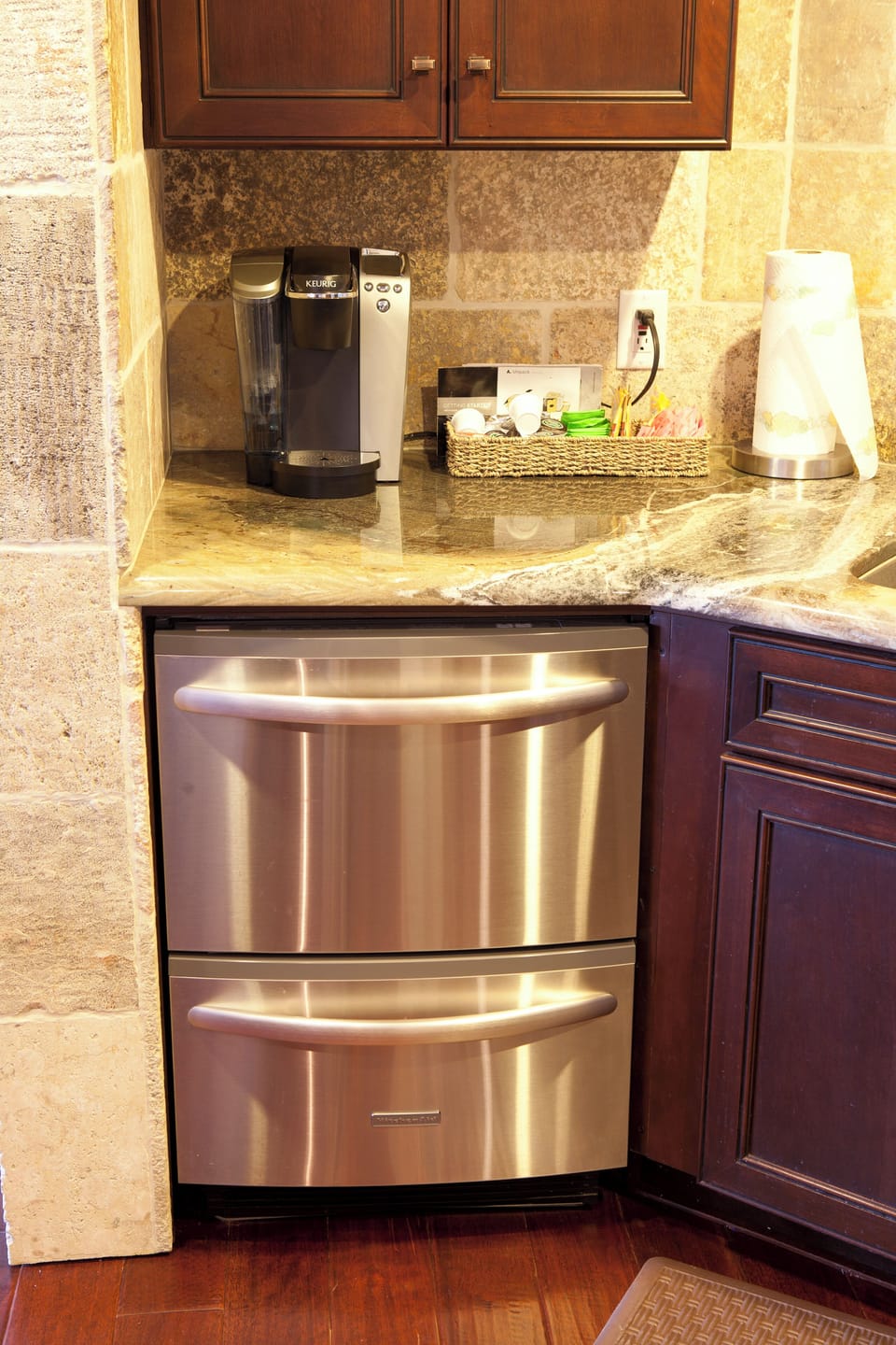 - Wake up to your favorite brew with the Keurig coffee station, complete with a selection of pods
- Handy beverage accessories and paper towels make mornings seamless
- Located right next to sleek double drawer refrigerators for added convenience