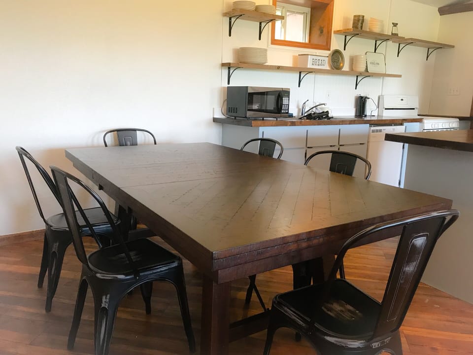 dining table open to kitchen and living room
