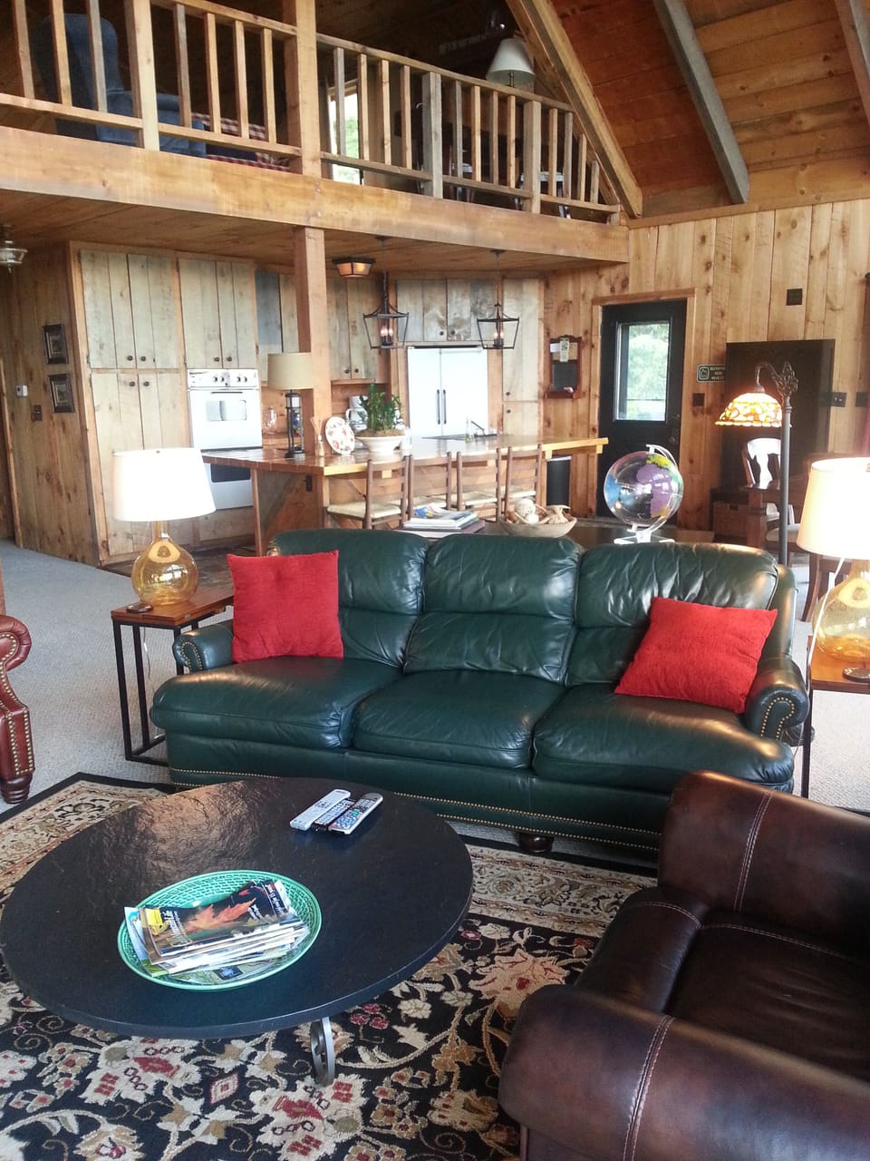 Leather den furniture, open floor plan with view to the kitchen.