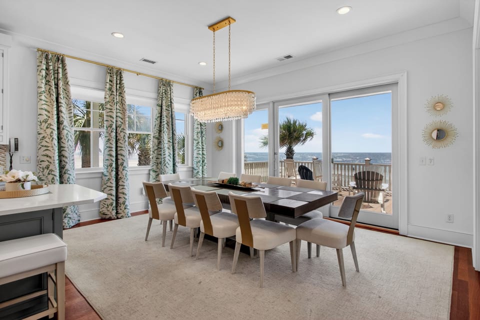 Your stunning dining room showcases ocean views through expansive windows, creating the perfect backdrop for memorable meals with family and friends.