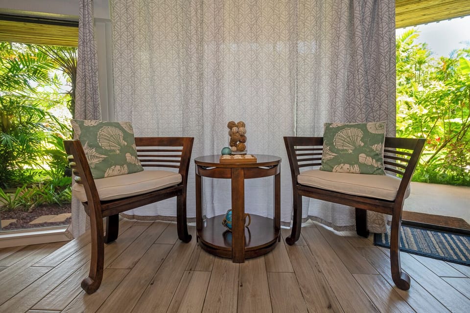 Just off to the side of the dining area there's a cozy seating area for 2. Situated between the lanai doors, this is a perfect place to throw the doors open and enjoy the breeze while unwinding with a book or a beverage!