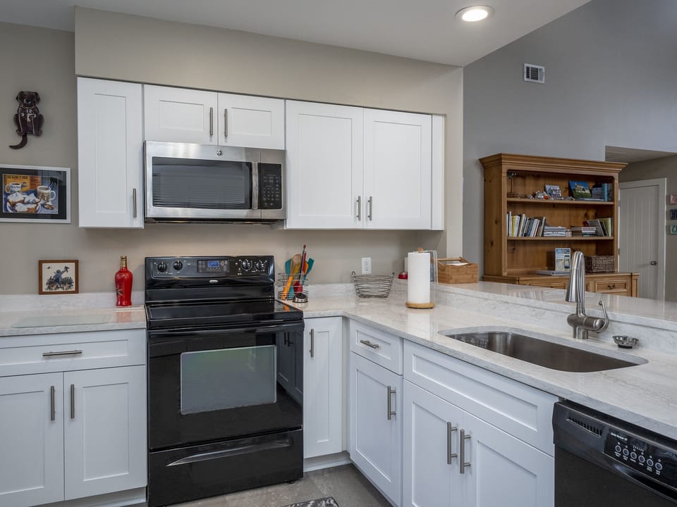 The open kitchen is equipped with what you'll need to cook.