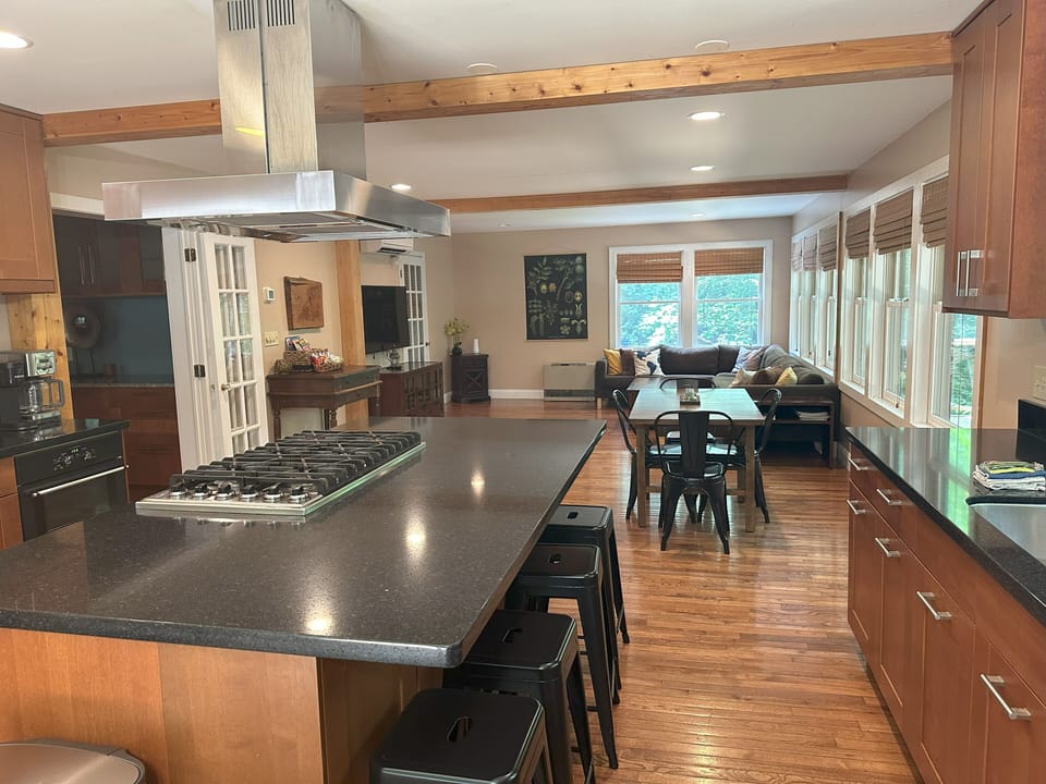 Kitchen flows into a spacious Family room with Dining Table and Sectional Sofa