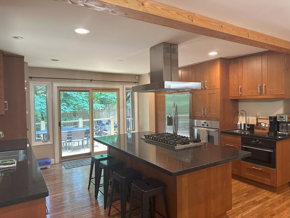 Gather around the Massive Kitchen Island for lunch or to assist the chef