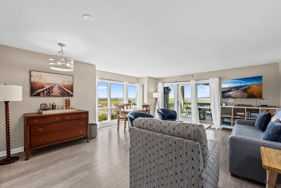 A beautiful wall of windows greets you with the beach beyond in the end unit.