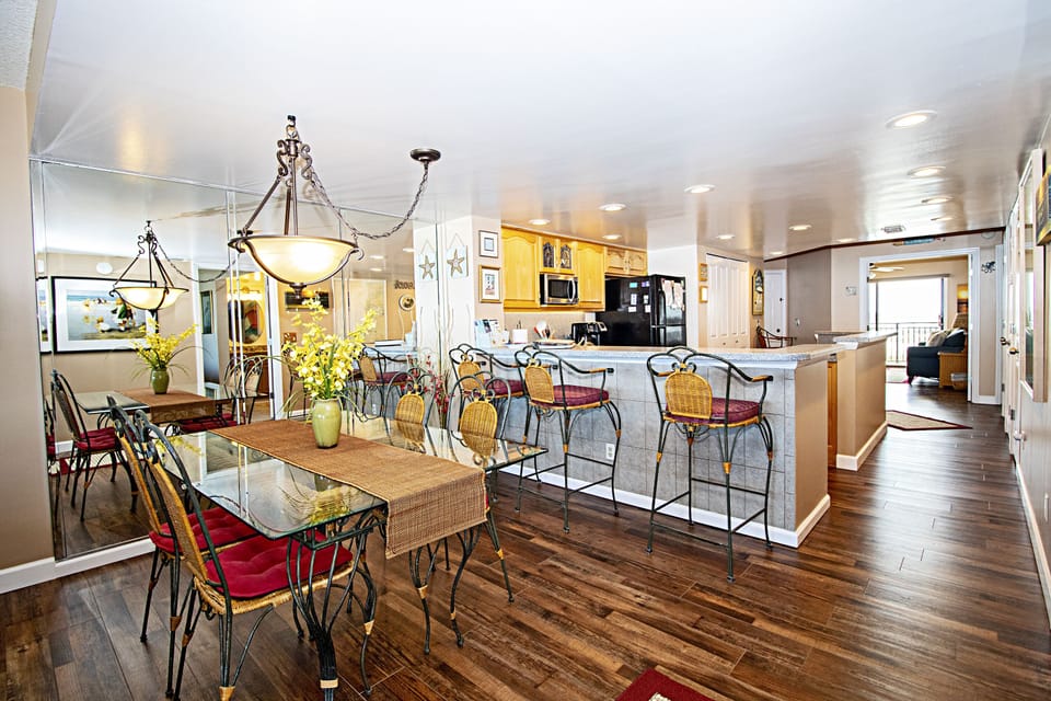 Dining area, kitchen bar area , den/br, guest br balconies on westside of condo
