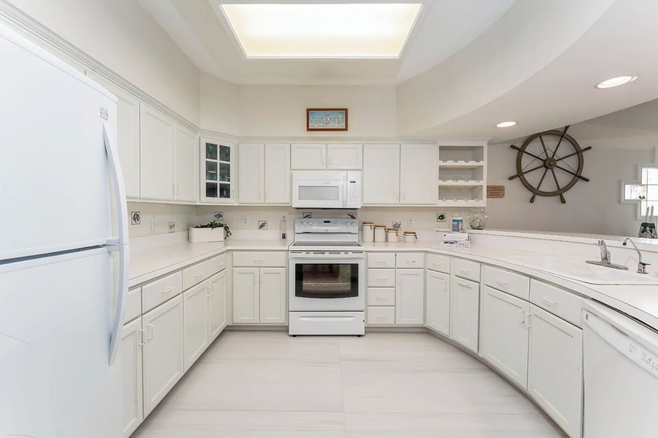 Chefâ€‘ready kitchen features ample counter space, full appliances, and a bright faux skylight for cooking together in comfort.