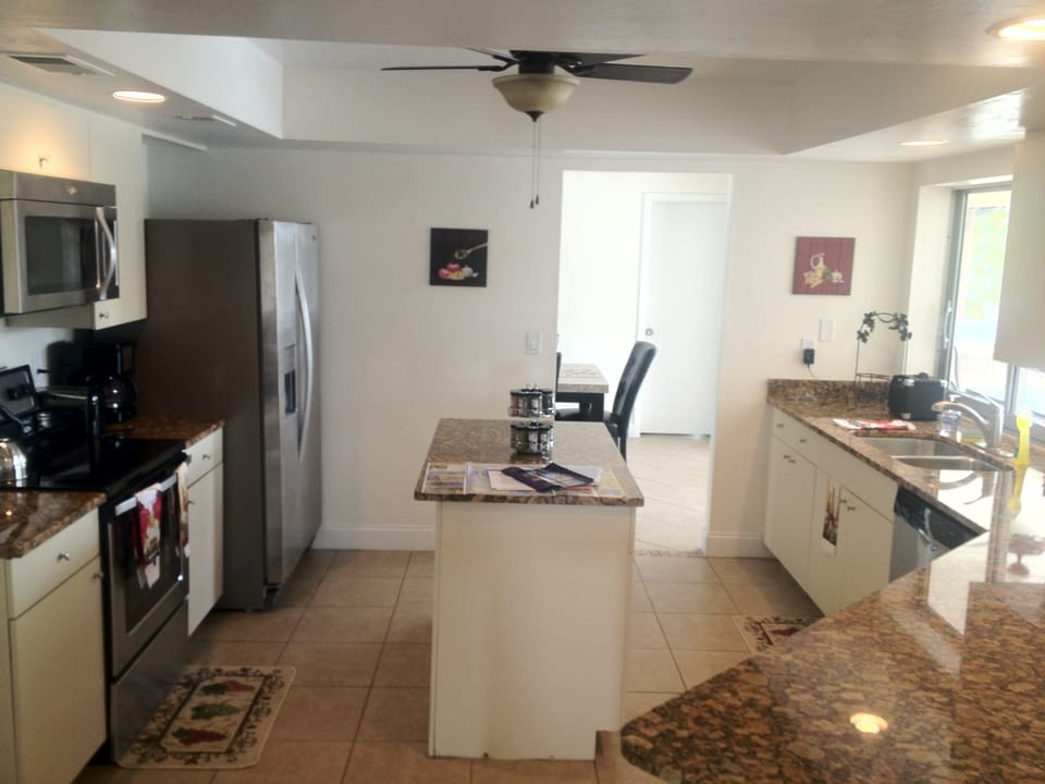 Double sink overlooking pool & canal, equipped with all basic cooking need!