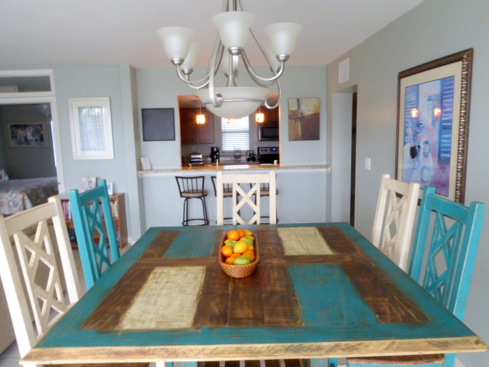Close up of dining area and bar that opens to kitchen..