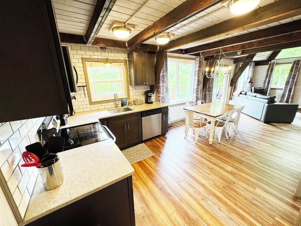 Full kitchen with pots, pans and drip coffee maker. 