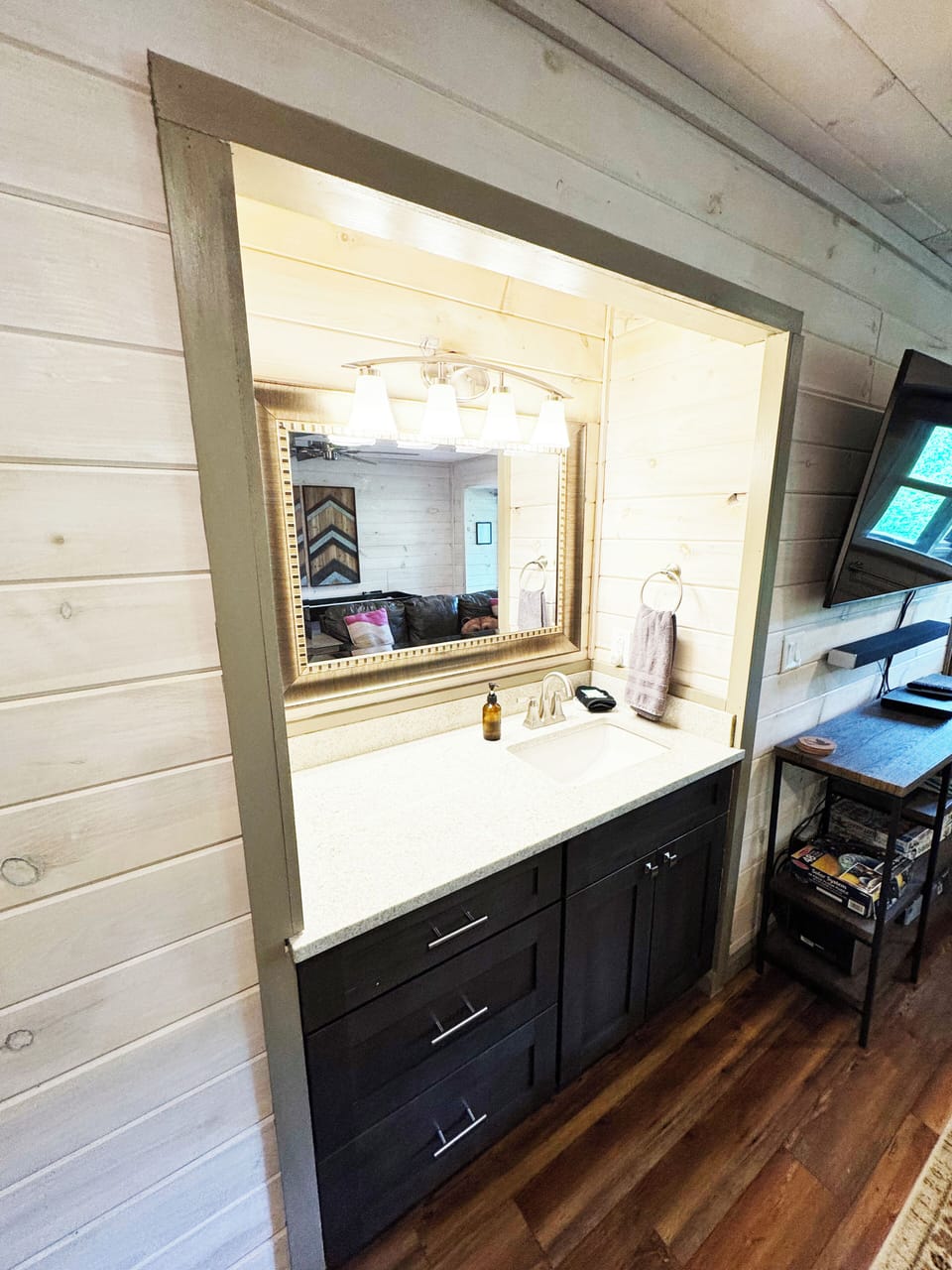 Kids bunk room with shuffleboard, games and sink. Hot tub located just outside. 