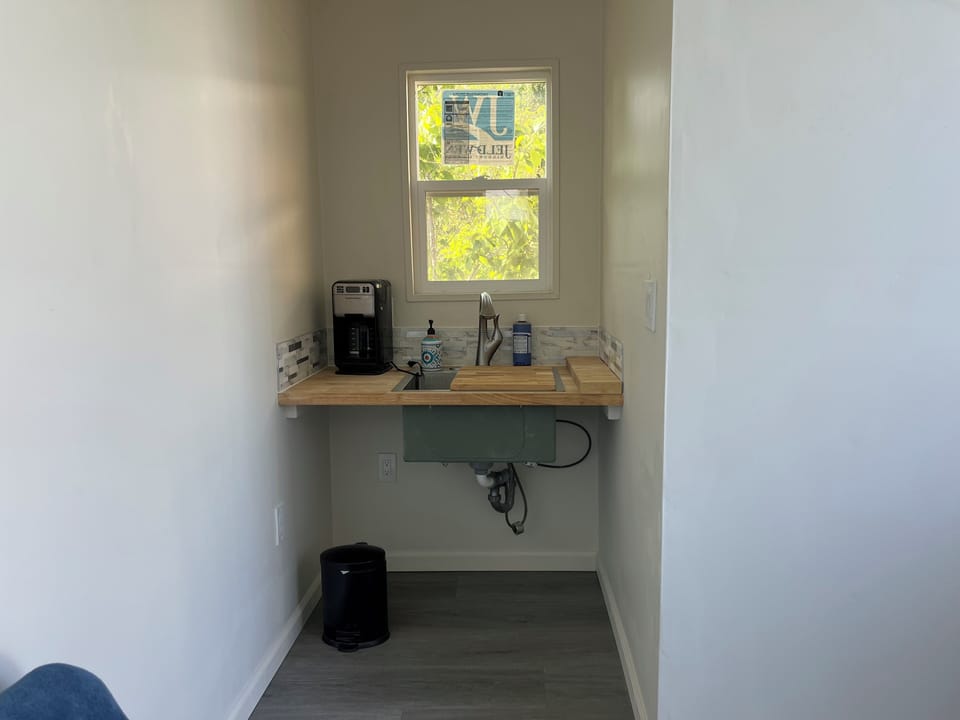 Small sink area in the pool house with coffee maker