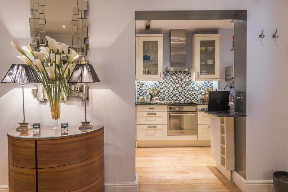KITCHEN ENTRY FROM LIVING ROOM.  Easy meal prep with many foods shops nearly.