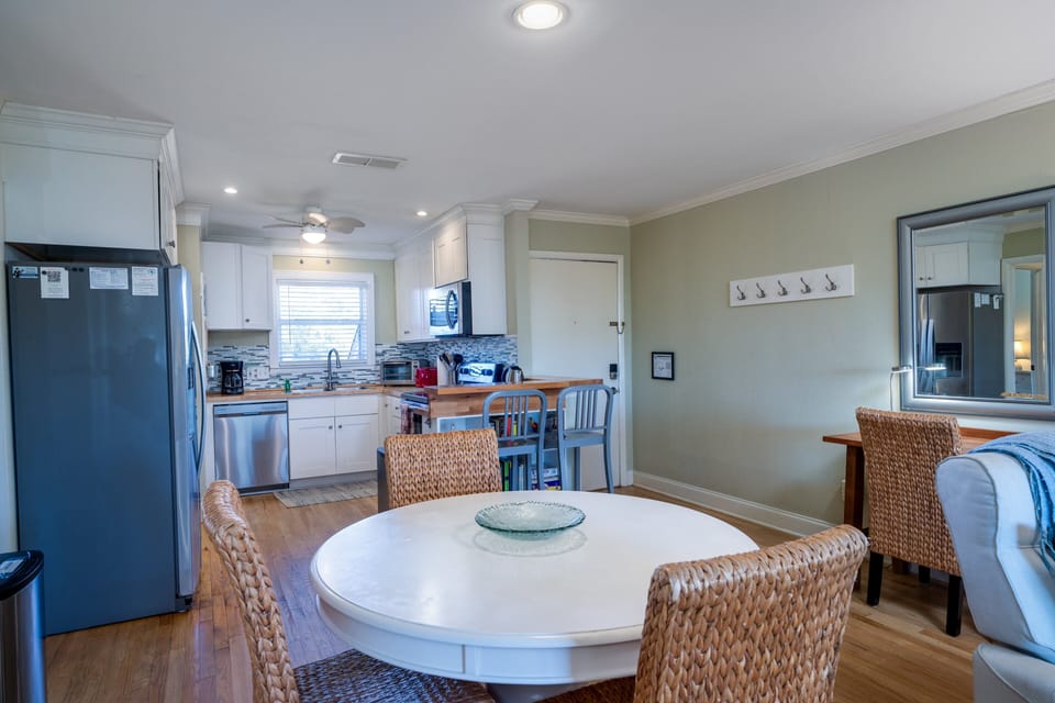 The dining table seats 4. There is additional seating for 2 at the kitchen counter and useful desk has been added.