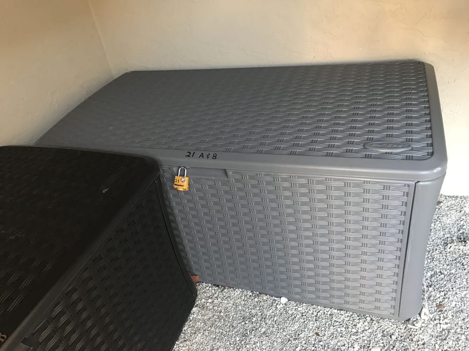 Storage locker w/Beach chairs, cooler on wheels & shell rake beneath stairwell.