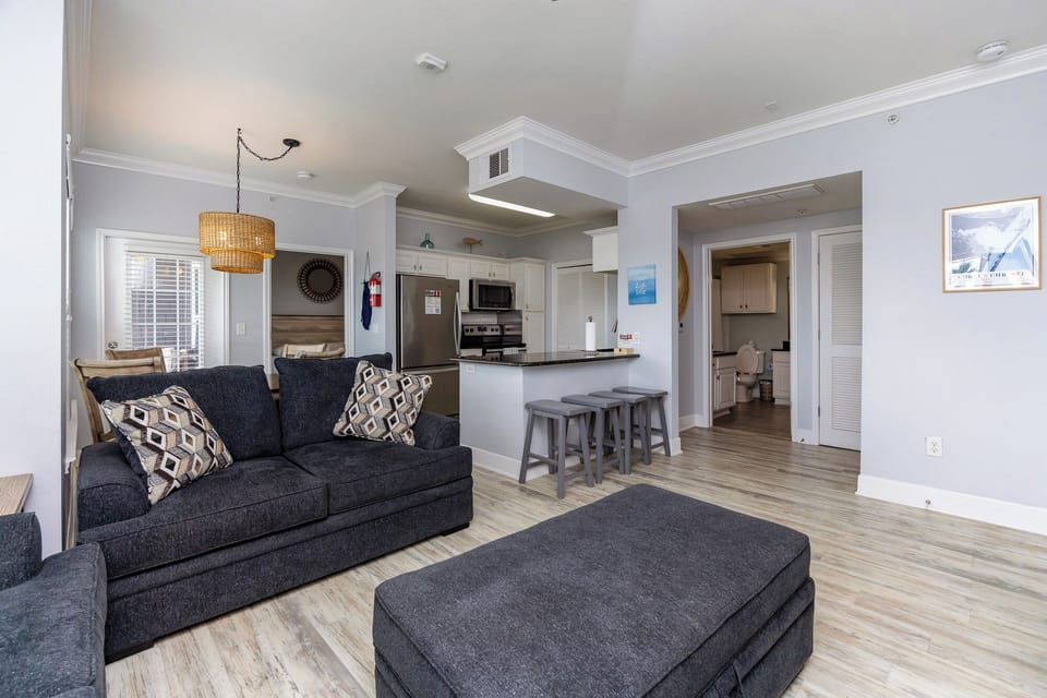 Relax in this bright, open-plan living space where your fully equipped kitchen flows seamlessly into comfortable seating areas.