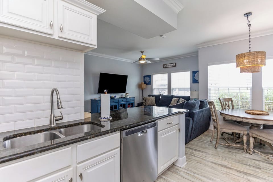 Your open-concept haven seamlessly blends the modern kitchen, cozy living room, and dining space into one inviting area perfect for gathering.