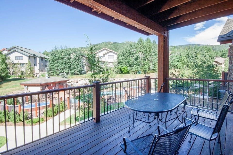 Deck overlooking the pool and 2 hot tubs
