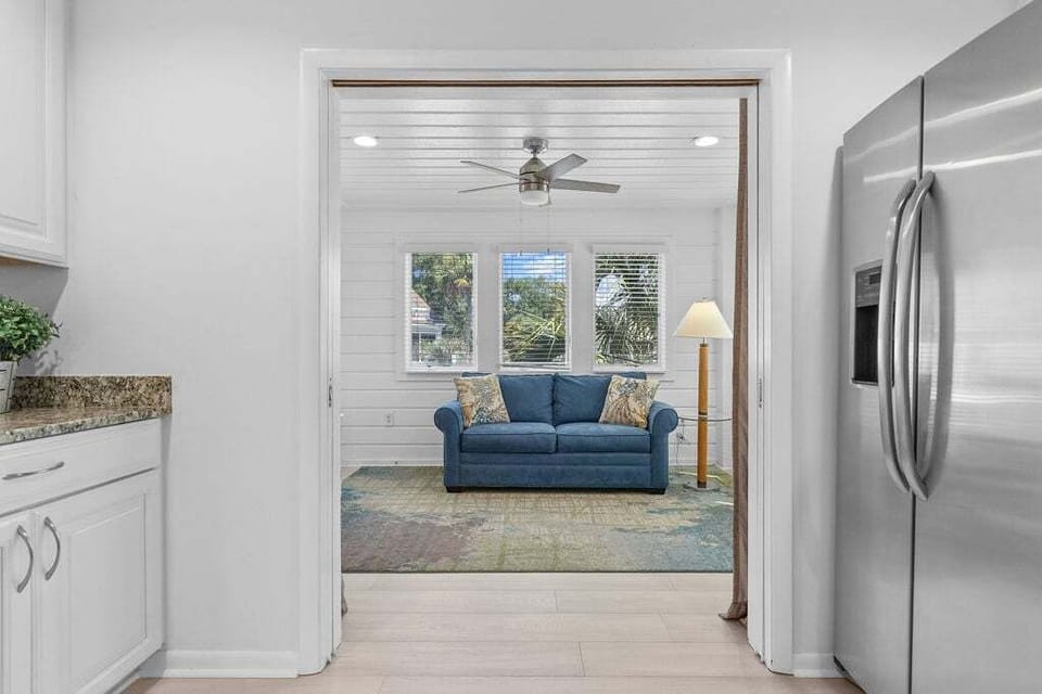 Sliding doors separate the sunroom from the kitchen and provide some privacy for this space