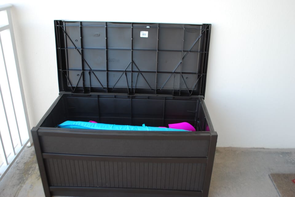 deck box filled with beach toys.