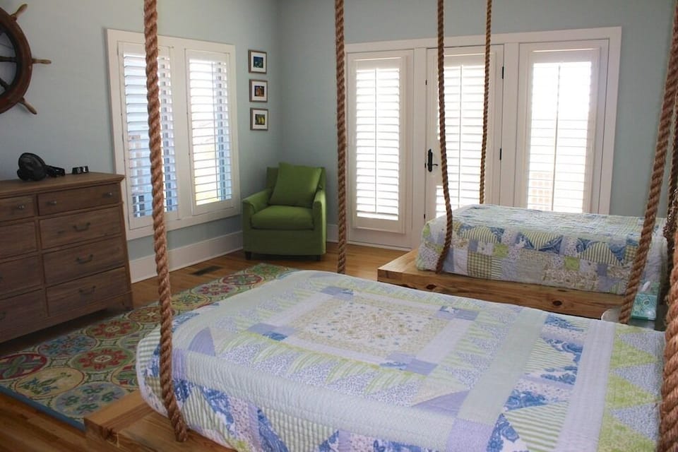 The 4th bedroom has two twin beds with ship ropes creating a unique bed frame.