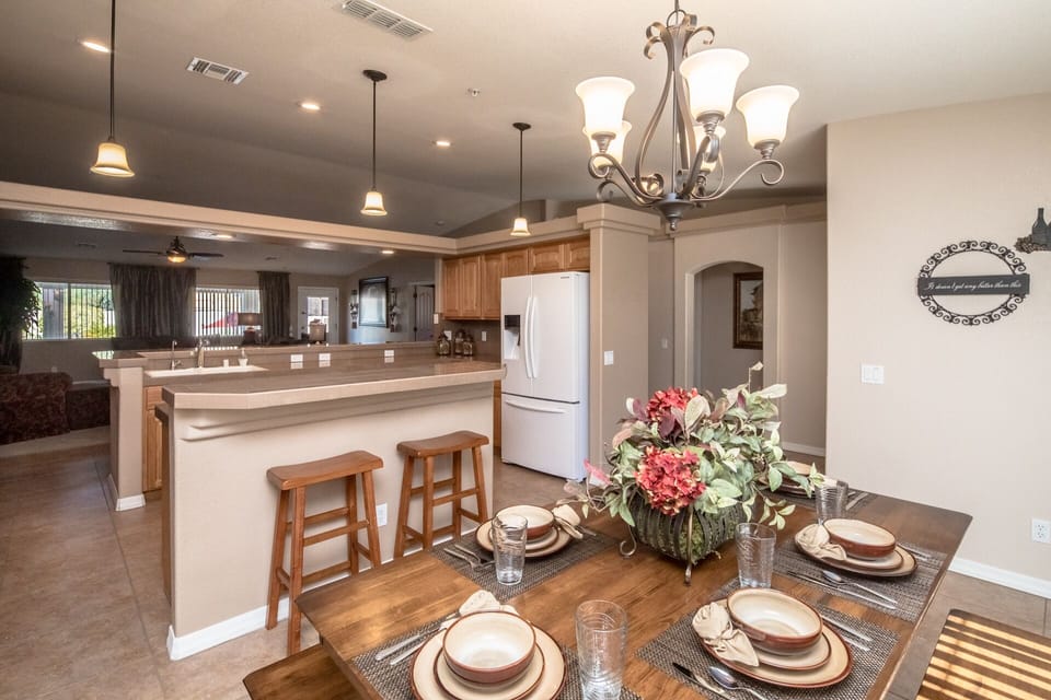 DIning area with a chandelier
and pendant lighting