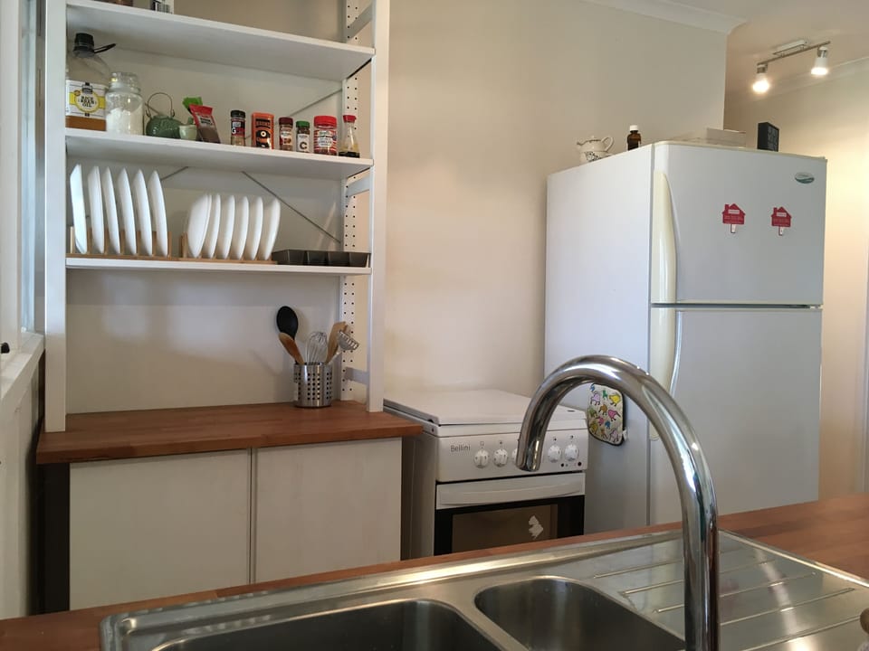 The kitchen has a full size fridge, electric stove and oven, a dishwasher