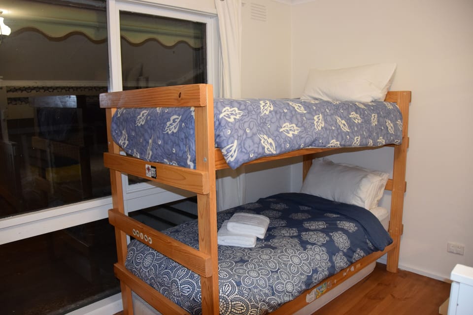 The second bedroom contains two set of bunks. These,