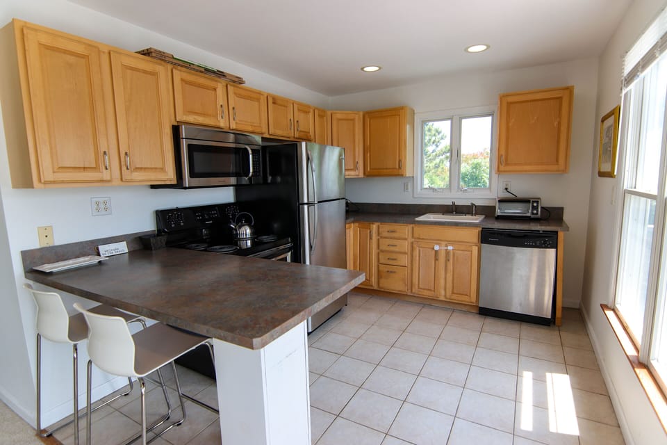 State of the art kitchen with stainless steel appliances and breakfast bar 