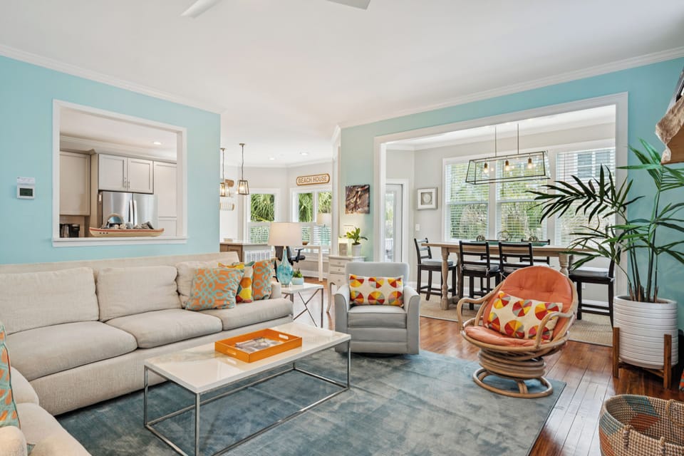 Unwind in your stylish living room with plush seating, vibrant accents, and an open-concept flow to your fully-equipped kitchen and bright dining area.