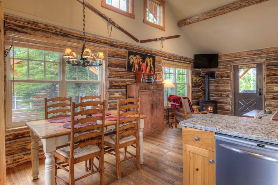 Kitchen opens to dining, living room, Smart TV, views.