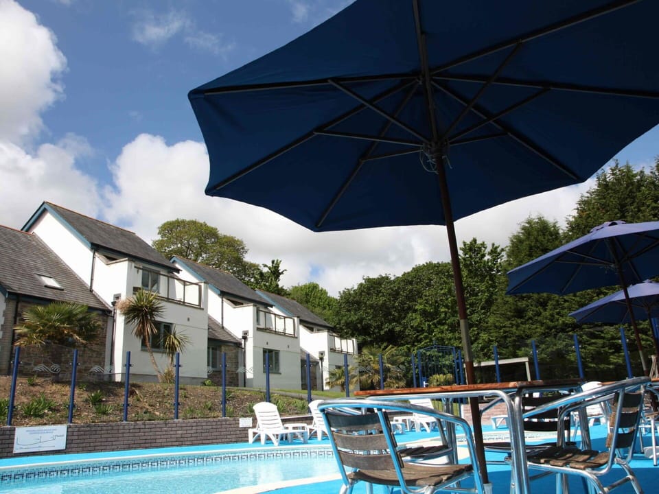 Sky, Plant, Water, Cloud, Property, Furniture, Building, Swimming Pool, Umbrella, Blue