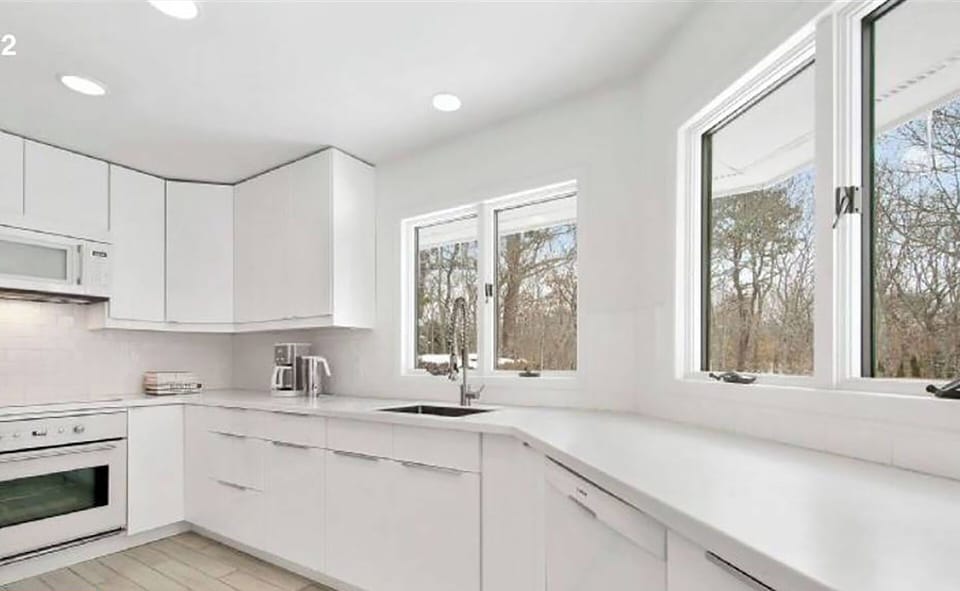 Chef's kitchen with windows looking out to pool.
