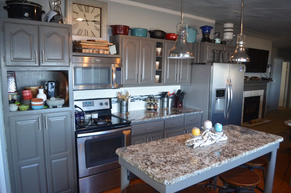 Large pantry, stove, large refrigerator, island with seating, pots.pans, etc.