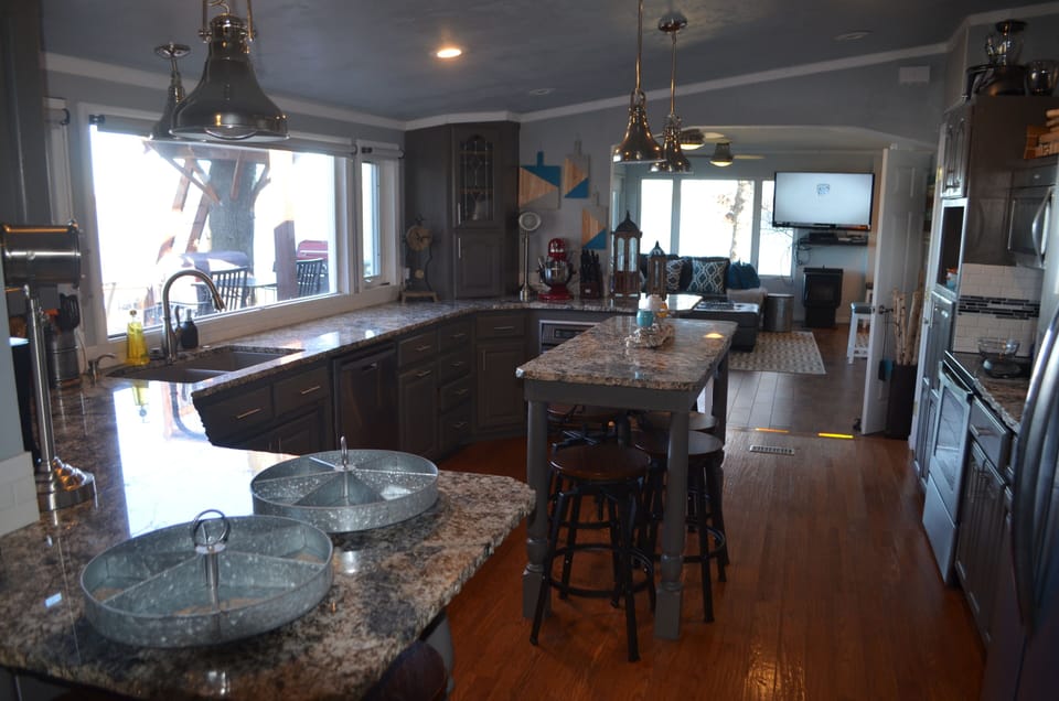 View of kitchen looking back to living room.  Lots of space, 2 ovens & more.