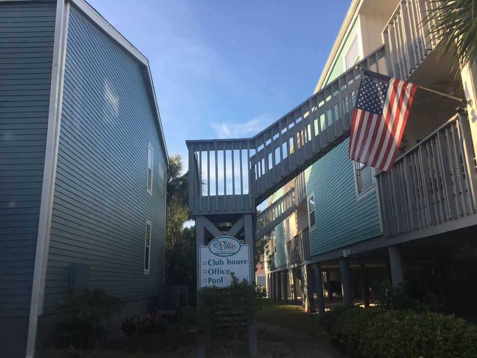 North of the parking lot of Building L, a short walk to the pool
