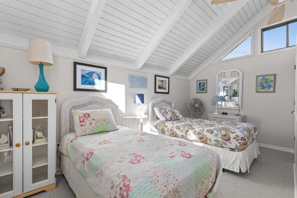 The upstairs loft serves as the third bedroom. It has two twin beds and is open to the living area below.