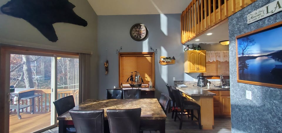 Sliding door to upper deck, featuring outdoor seating and Blackstone Griddle. 